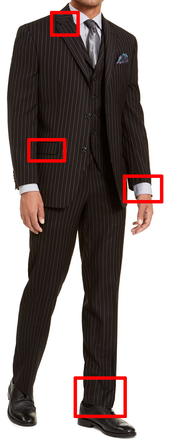 The stripes on the lapels and jacket pocket do not line up here. The suit is also too short for the model: the jacket sleeves expose too much of his shirt cuffs, and the trousers do not break at all across his shoes.